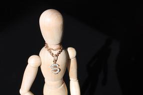 doll with dollar sign as a symbol