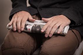 folded Newspaper in male hands