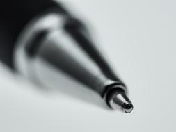 Black and white photo, with the close-up of the metal end of the pen