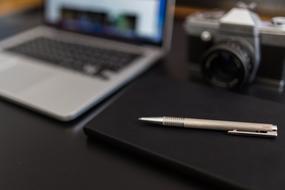 MacBook and black notebook