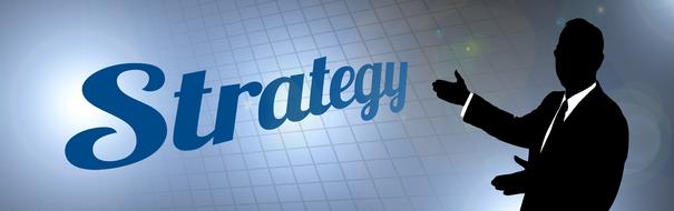 Silhouette of a businessman and "strategy" sign, at checkered background