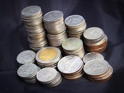 Stacks of the colorful, shiny metal Thai coins, with the images