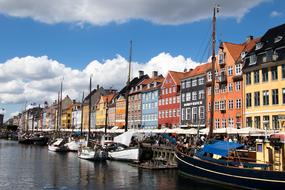 Boats parked on water at embankment of old European city