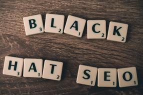 "Black Hat SEO" signs on the cubes, with the numbers, on the wooden surface