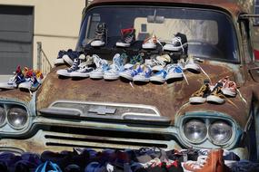selling shoes on a rusty car