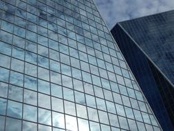 sky is reflected in the glass building