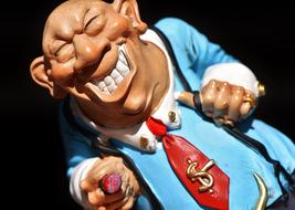 funny figurine of a greedy businessman