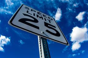 road sign with inscriptions on the background of the sky with clouds
