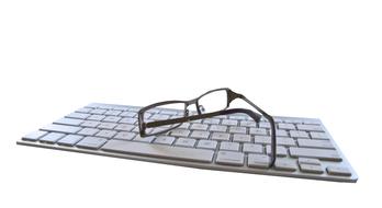 glasses on gray keyboard