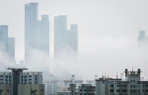 city skyline of skyscrapers in fog