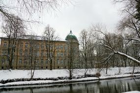 old school building on waterfront at winter, germany, tuttlingen