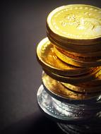 tower of gold and silver coins close up