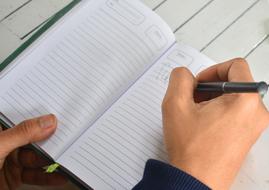 male person Writing on notebook