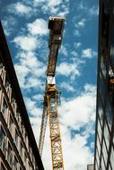 construction crane over buildings, bottom view