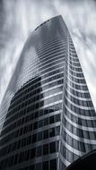 black and white photo of a skyscraper with a glass facade