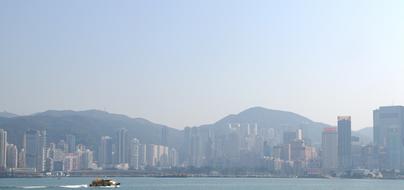 Beautiful skyline of Hong Kong with the shore and mountains