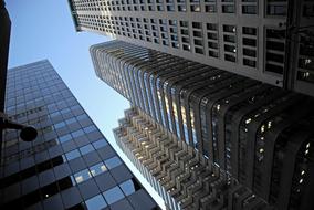 Low angle shot with the skyscrapers, with the colorful lights and reflections, under the blue sky