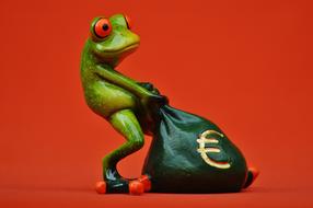 funny figurine of a frog with a bag of money