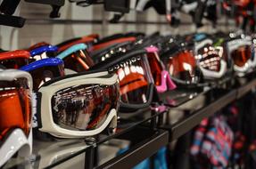 Colorful, shiny skiing goggles, in the row, in the shop