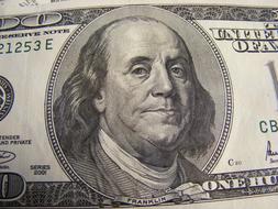 Portrait of Benjamin Franklin, on the dollar banknote, with the numbers and signs