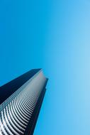 Low angle shot of the shiny building, with the windows, under the blue sky, in sunlight, in Seattle, Washington, USA