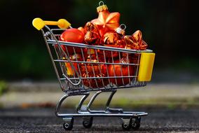 Colorful and beautiful Christmas decorations in the metal and yellow shopping cart