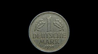 old german coin on black background