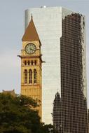 clock tower near a skyscraper in canada