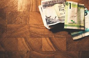 cash on a wooden surface