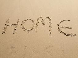 the inscription home on the sand
