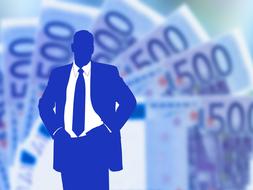 silhouette of a businessman on the background of a fan of euro banknotes