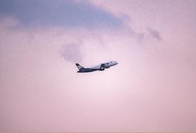 blue Plane in Flight at purple sky