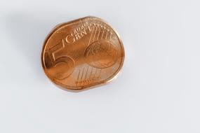 curved 5 cent coin