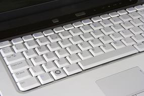 Close-up of the laptop with shiny, white and grey keyboard