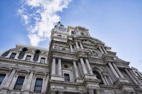 Beautiful, decorated town hall, at blue sky with white clouds on background in Philadelphia, USA