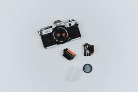 the film lies next to the camera on a white background