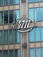 Beautiful, shiny "4711" sing on the facade of the building with windows