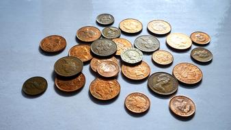 Different, shiny metal coins on the grey surface