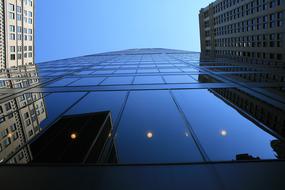 glass Skyscraper facade between stone ones