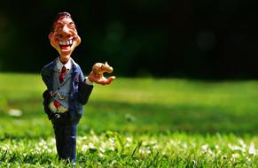 funny laughing Businessman figurine on lawn