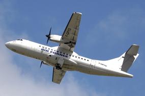 airplane with propellers in the sky on a sunny day