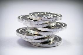 stack of silver coins on white background