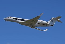 a private jet flies in the blue sky