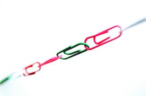 Chain, made of the colorful paper clips, at white background