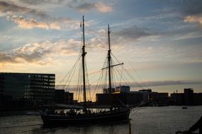 Beautiful ship on the water near the coast at colorful sunset