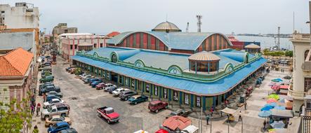 Beautiful and colorful art center, among the buildings and cars, under cloudy sky in Maracaibo, Venezuela