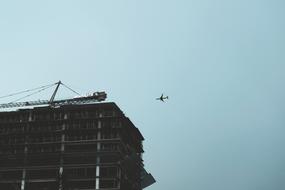 Airplane on Sky and Building