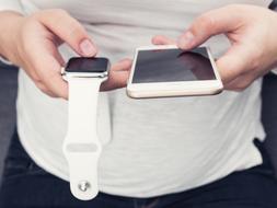 smartphone and apple watch in hands