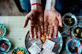 painted hands on the background of a tray with money