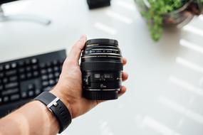 camera lens in a man's hand